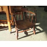 A Victorian elm deep seat Captains chair,