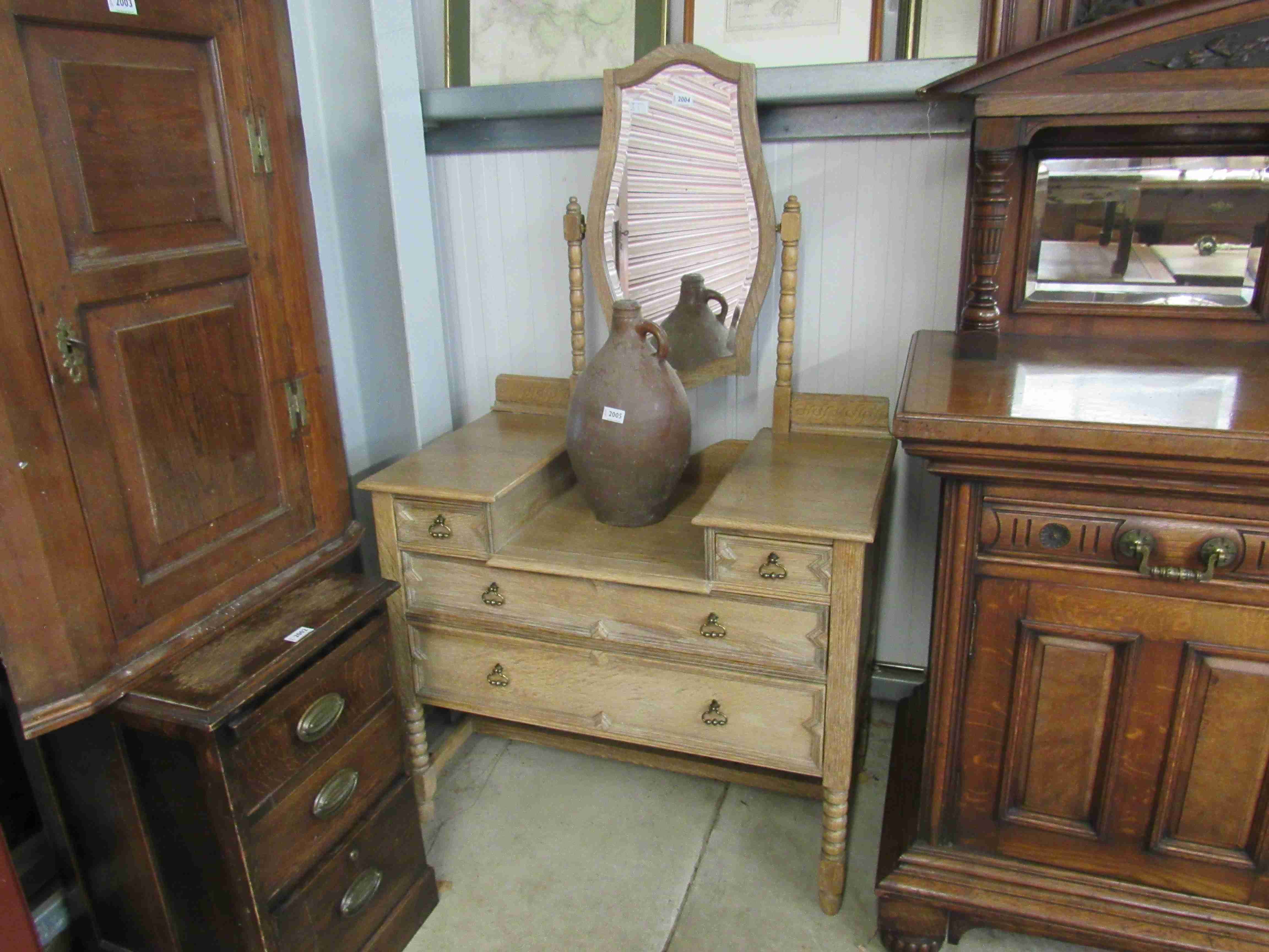 A 1930s stripped oak dressing table with mirror back and four drawers