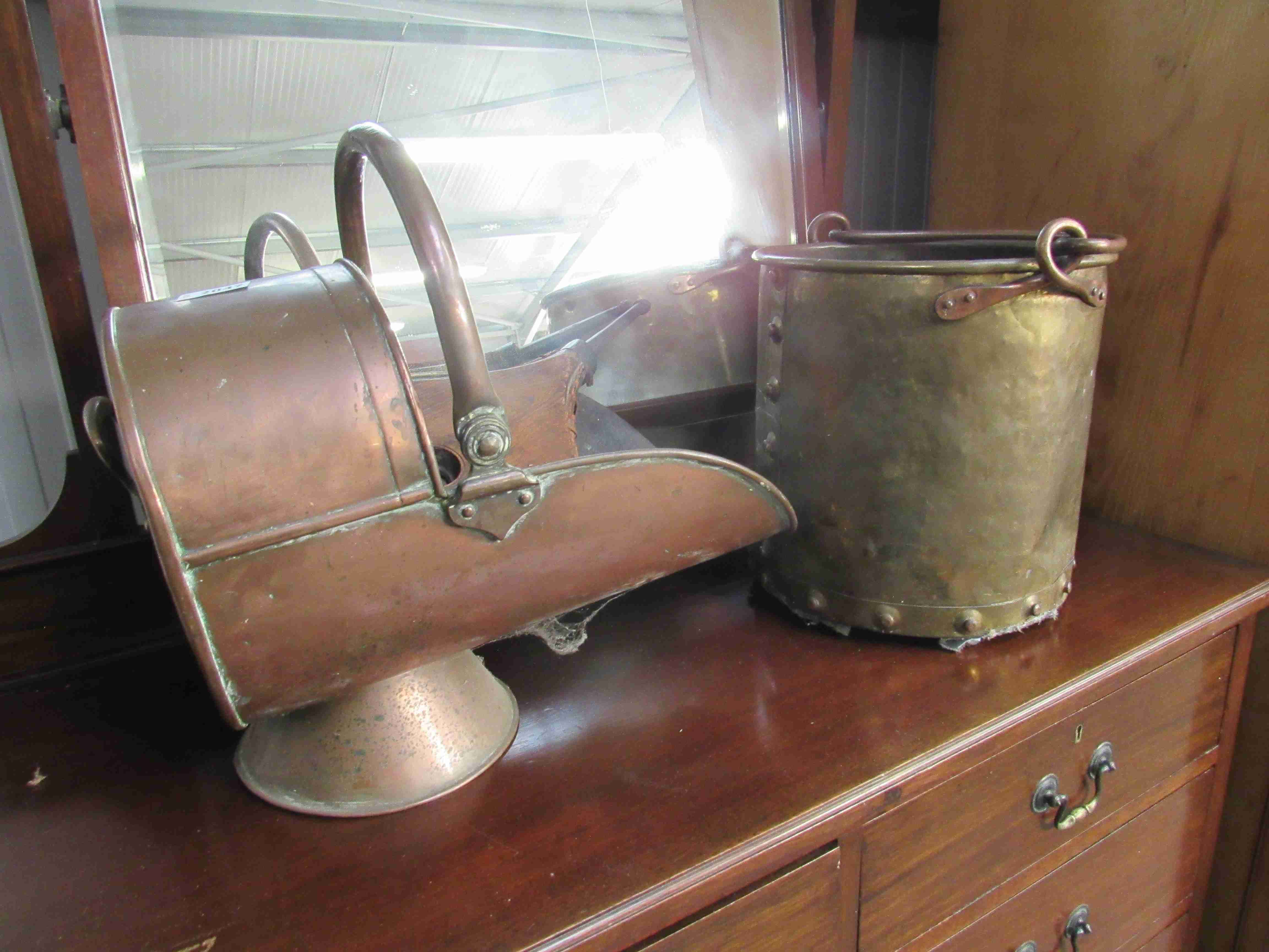 A copper coal helmet and bygone bellows and brass bucket