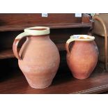 Two terracotta pots with handles and glazed rims