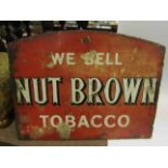 An enamel sign: We Sell Nut Brown Tobacco,