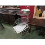 A three tier glass and metal tea trolley