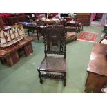 A 17th Century revival carved oak bergère chair with coronet top over barley twist supports and