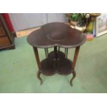 A triform top occasional table with undertier on slender shaped legs,