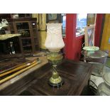 A Victorian oil lamp with brass base with foliate detail, half fluted brass reservoir,