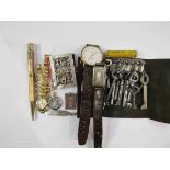 A selection of items including mother-of-pearl miniature book, wristwatches, silver ingot,