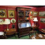 An astragal glazed mahogany cabinet on bureau base, two short over two long drawers.