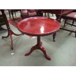 A hardwood circular top tripod coffee table,