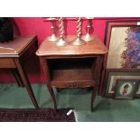 A French oak bedside cabinet with carved decoration on cabriole legs,