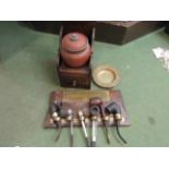 A box of pipes and an oak pipe rack with tobacco jar