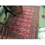 A wool rug in terracotta and black and beige,