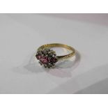 A 9ct gold ring set with three rubies enclosed by six individually set diamonds. Size O/P, 2.