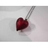 A heart pendant on chain,