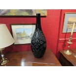 A black glass vase with leaf detailing,