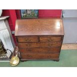 A Georgian oak bureau, fitted interior over two over three drawer base on bracket feet,