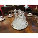 Three crystal glass decanters on silver plated tray