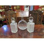 Three lidded glass decanters,