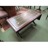A reproduction coffee table with leather top and drop leaves