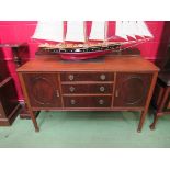 A 1930's Regency style mahogany sideboard, three central drawers, flanked by doors,
