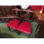A set of four Victorian carved mahogany dining chairs on ring turned legs