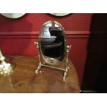 A brass dressing table swing mirror with turned supports on faceted feet (Mirror approx 27cm,