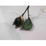 A cold painted solid bronze conker with leaf, the bottom stamped and numbered 144/150,