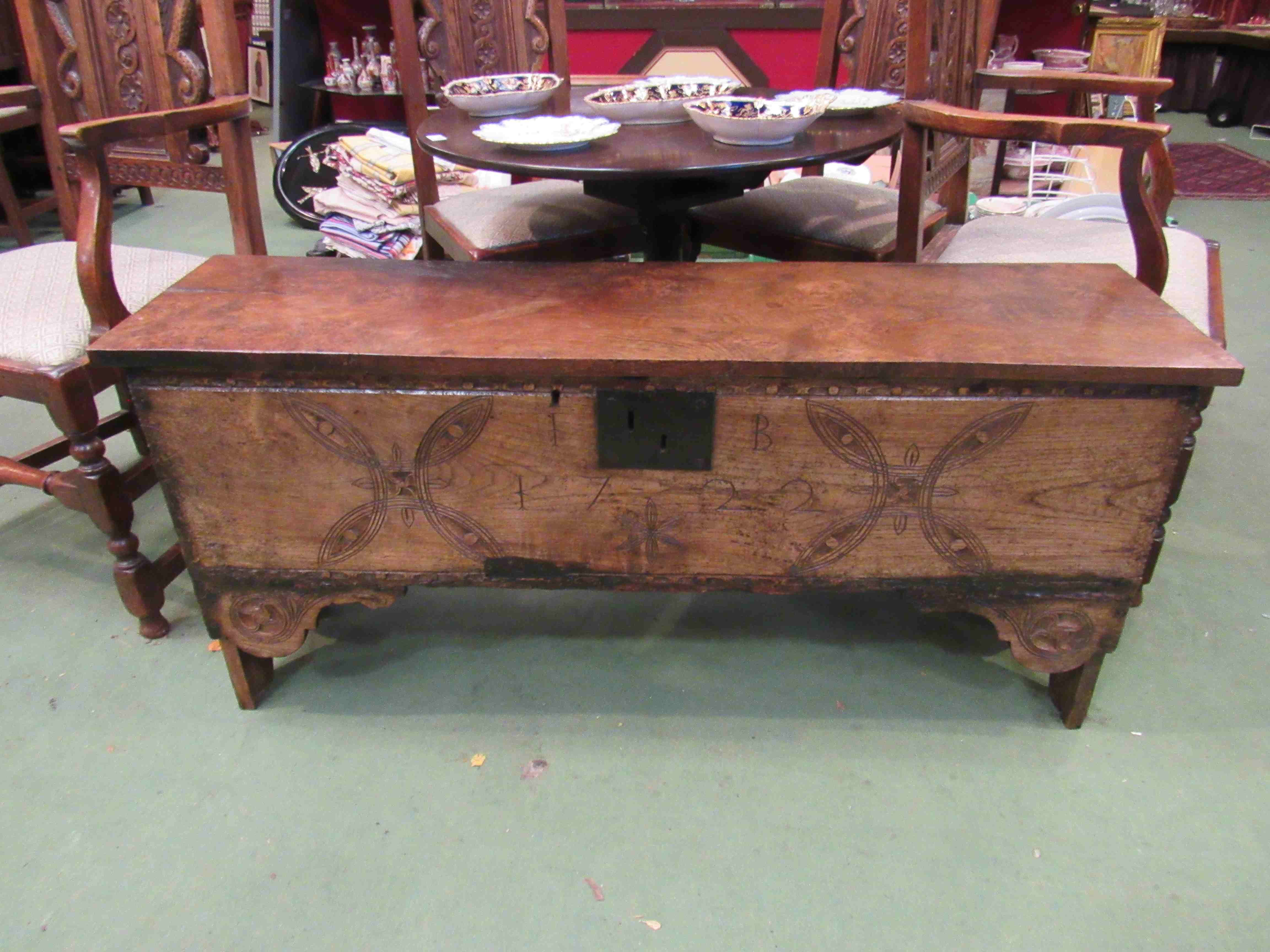 A six plank elm coffer with carved front panel, dated 1722, candle box to interior,