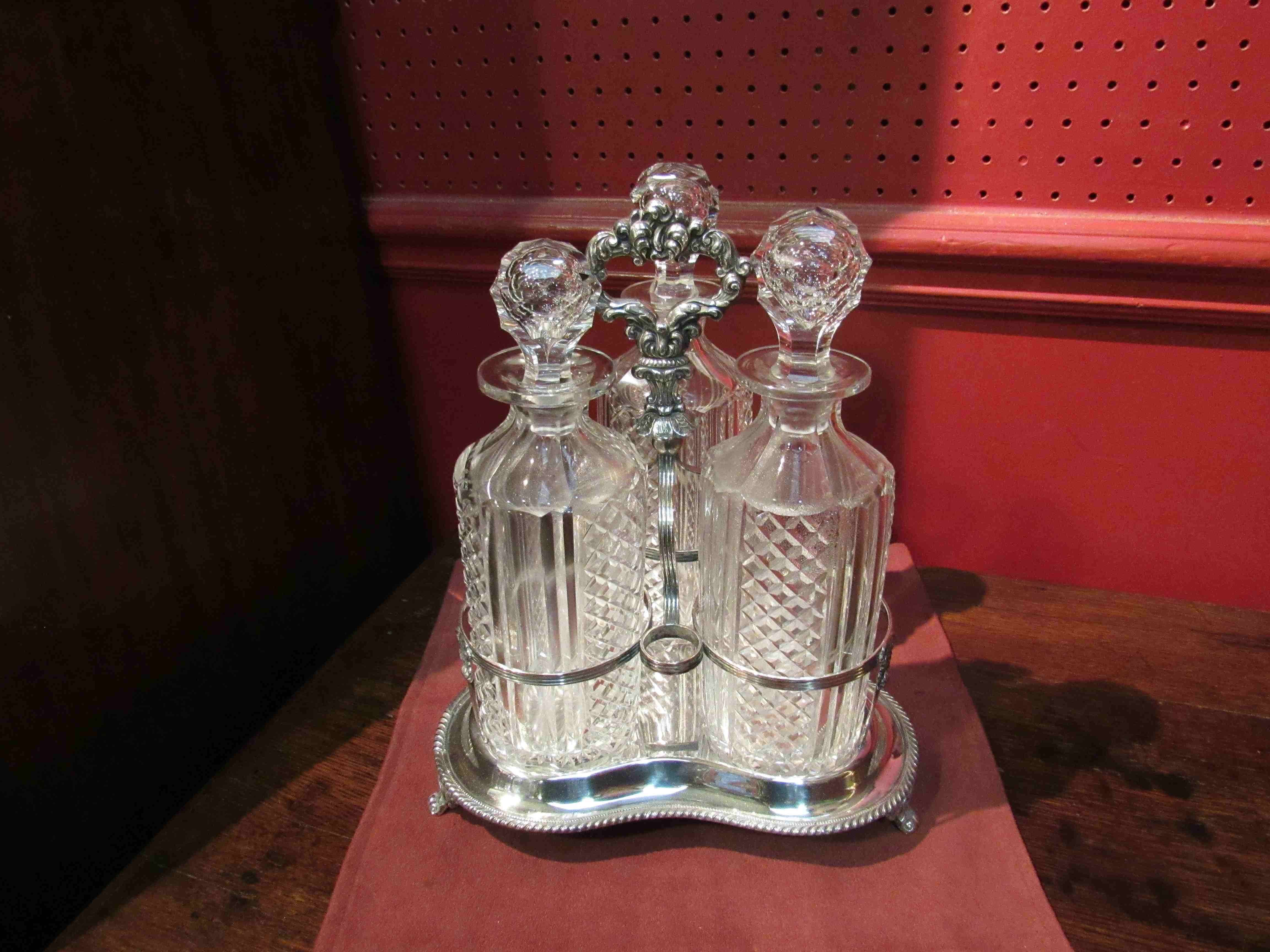 A Victorian silver plated Tantalus with three cut glass decanters