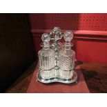 A Victorian silver plated Tantalus with three cut glass decanters
