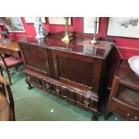 An early to mid 20th Century Dutch style sideboard with two doors over two drawers,
