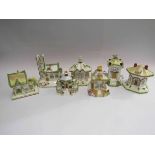 Seven Coalport handpainted pastille cottages including "Village Church" and "Thatched Cottage"