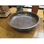 A handcrafted African hardwood fruit bowl with animal frieze depicting Rhinos,