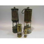 Four assorted miners lamps including miniature examples