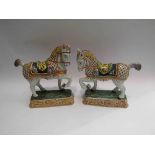 A pair of faience prancing horse figures,