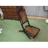 A 19th Century folding chair with carved seat and backrest having a carved coronet & Prince of