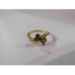 A gold ring with ruby trefoil and diamond trefoil set in a twist, 18ct gold. Size M, 2.