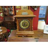 An early 20th Century oak mantel clock of Arts & Crafts design, Roman chapter ring,