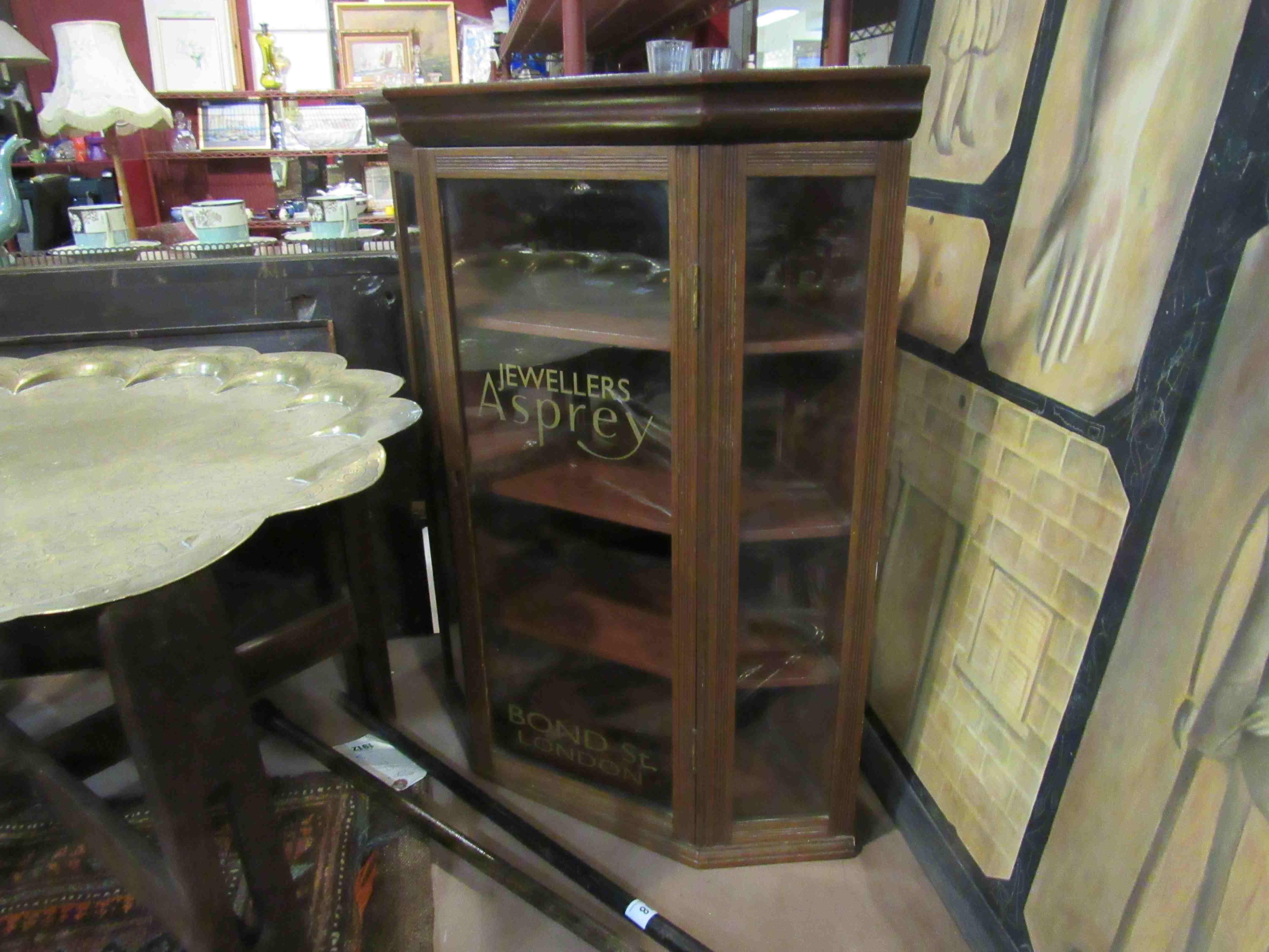 An Edwardian mahogany counter top display cabinet with painted advertising glass panels,