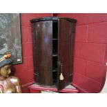 A George III oak bow front two door wall hanging corner cupboard with "H" hinges,