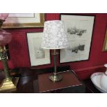 A bronzed metal table lamp with cream shade,