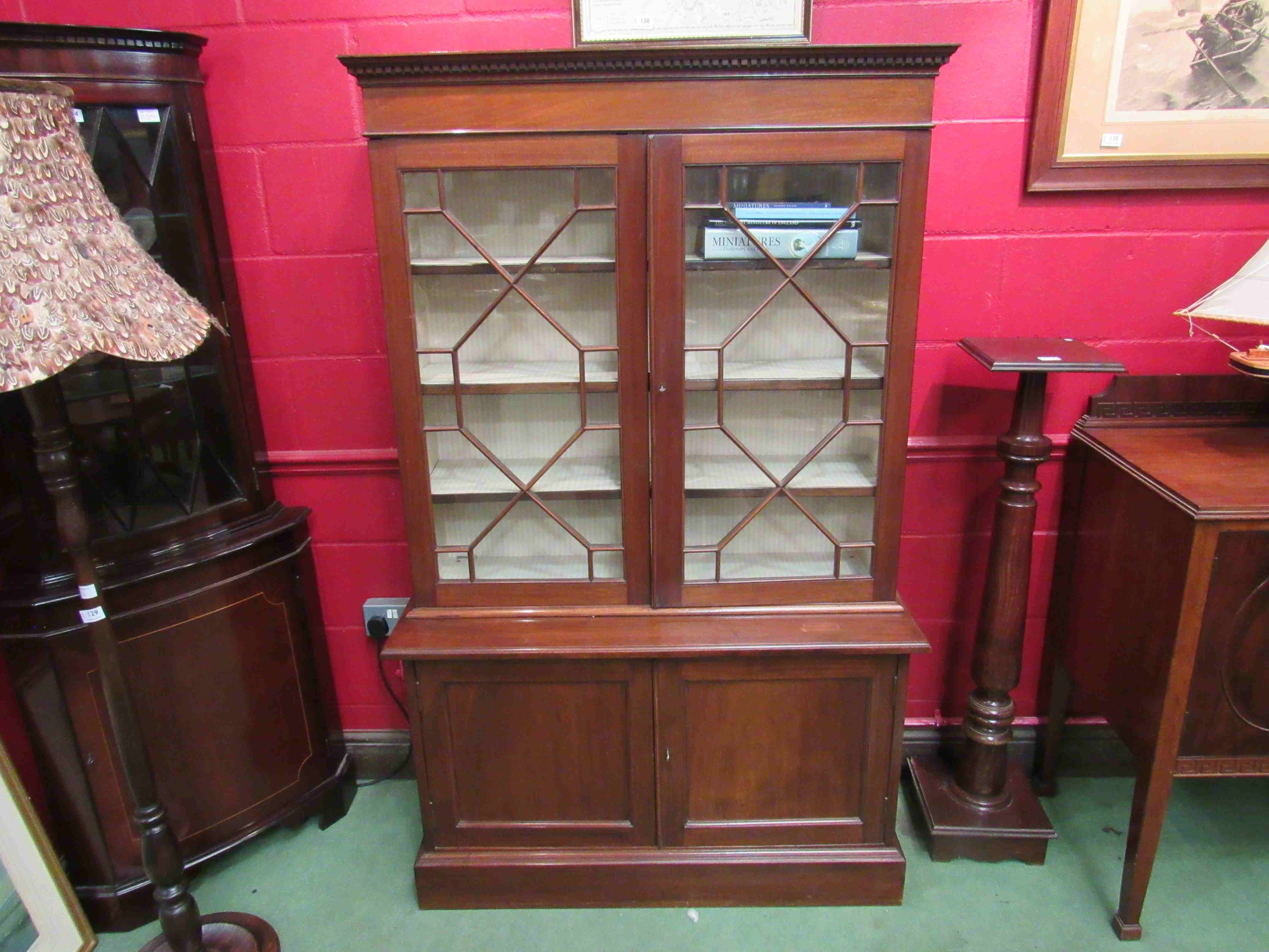 A 1930's Regency style mahogany glazed bookcase,