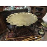 An Indian brass-top coffee table on hardwood base,