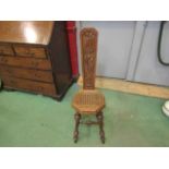A late 19th Century carved oak high back prayer chair with monogrammed shield cartouche,