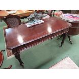 A Victorian mahogany side table the canted corner top over two frieze drawers on carved and reeded,