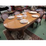 A Deco dining table with oblong wood and glass top,