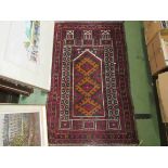 An Eastern red and black ground wool rug with multiple floral borers and fields in red,