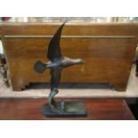 A French Art Deco style spelter sculpture of bird in flight, attributed to Tedd, on plinth base,