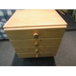 A modern pine chest of four drawers,