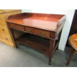 Circa 1860 a mahogany two tier washstand the three quarter raised back and one piece top over two