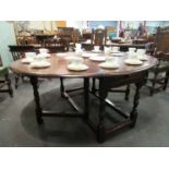 An 18th Century and later oval top drop leaf dining table with single end cutlery drawer over